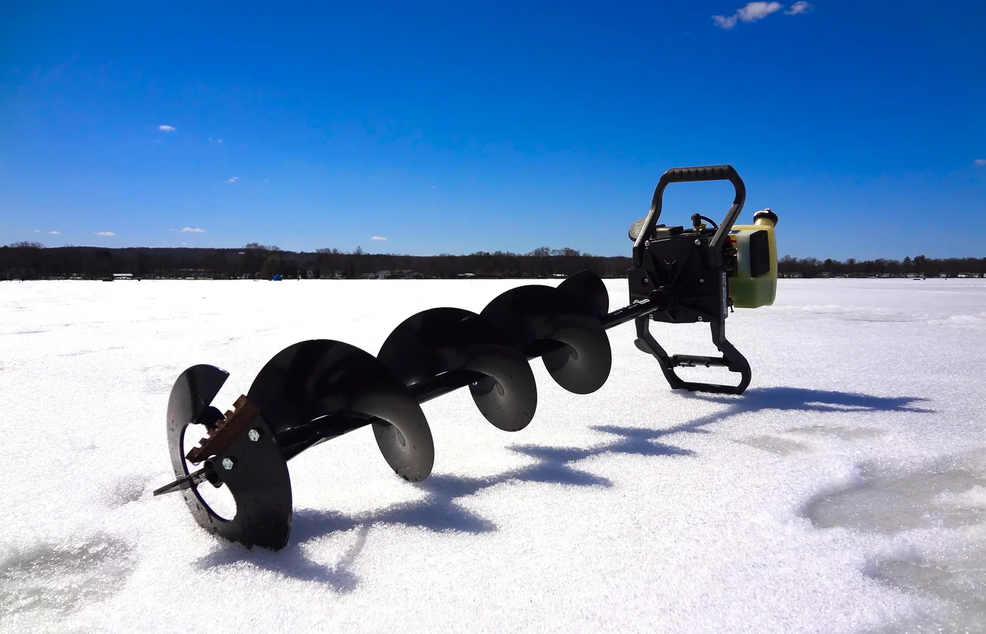 Close view of an earth auger showing the spiral flighting, pilot point and cutting edge