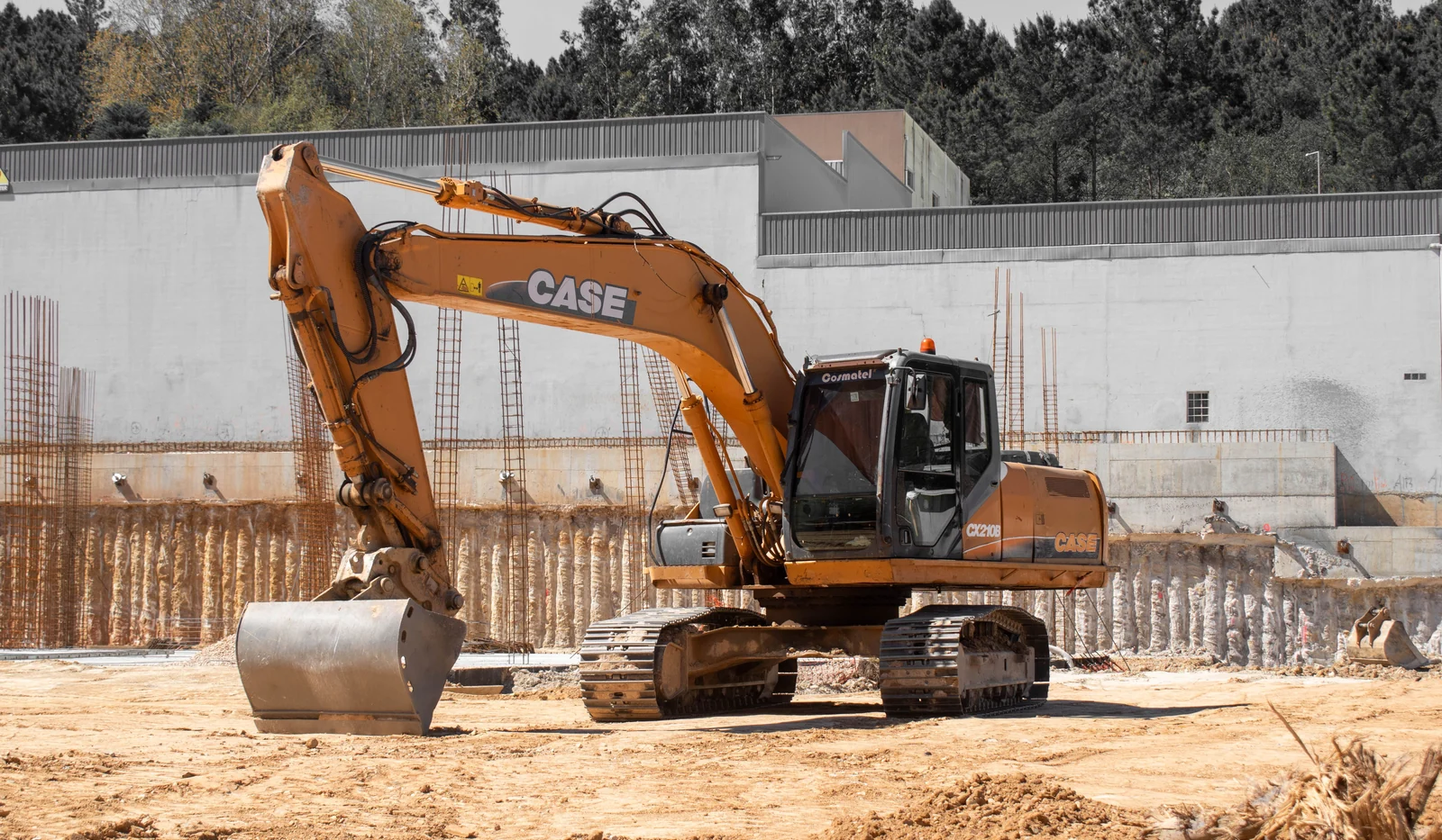 Tracked excavator fitted with a digging bucket on a construction site