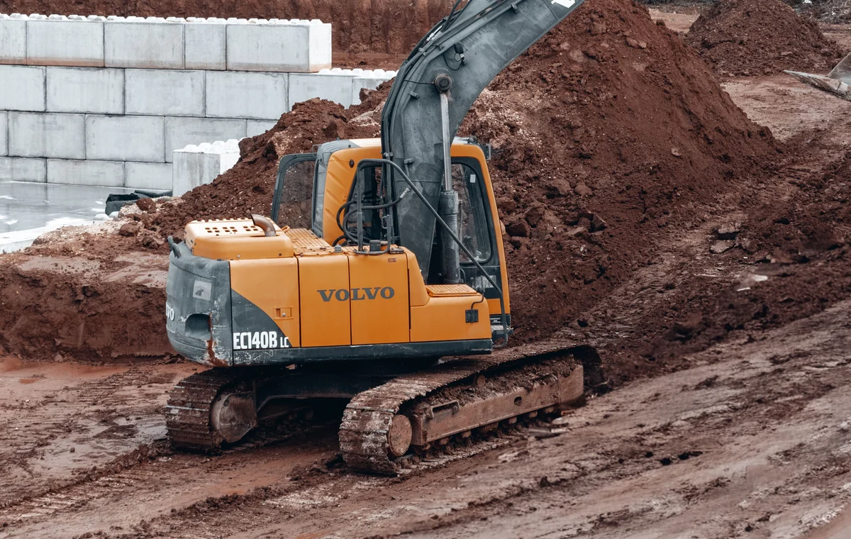Tracked excavator working during site preparation and earth grading