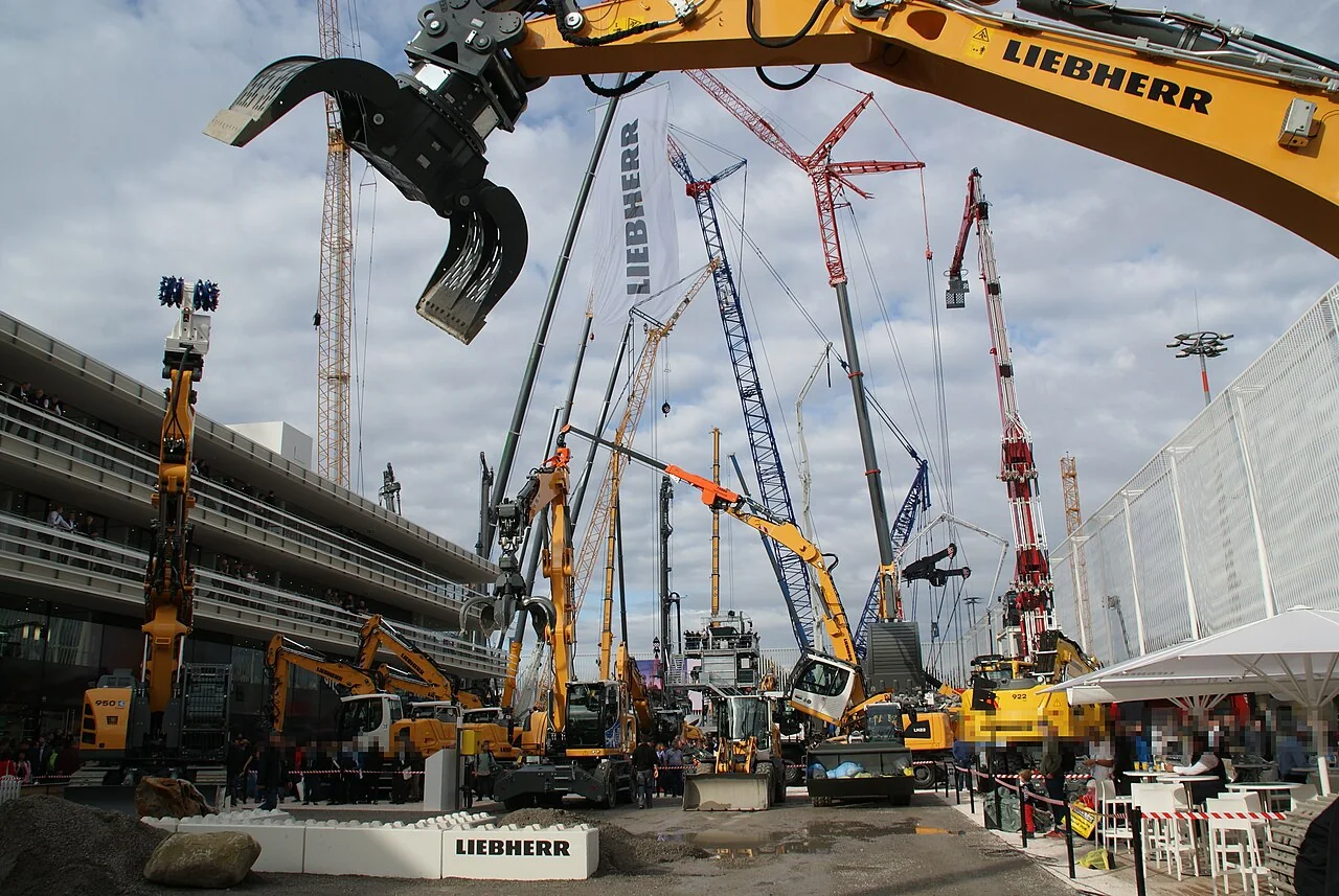 Large exhibition area showing excavators and multiple sorting grapple configurations