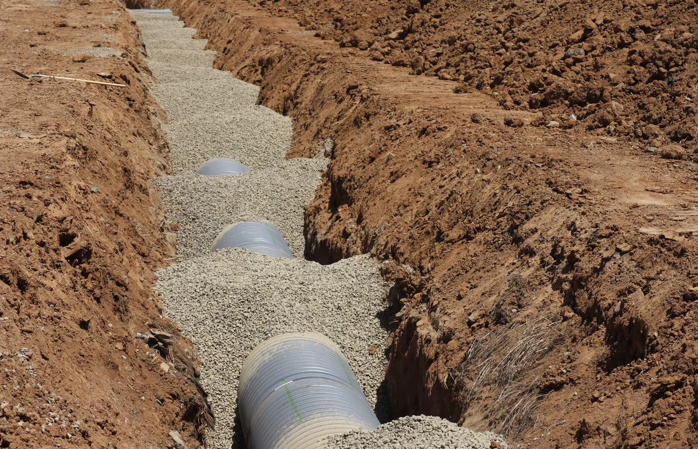 Prepared drainage trench with pipe and graded bedding material