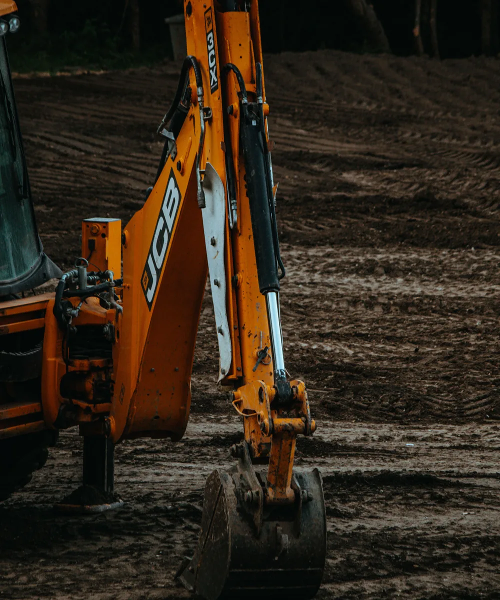 Backhoe excavator using a narrow bucket during earthwork